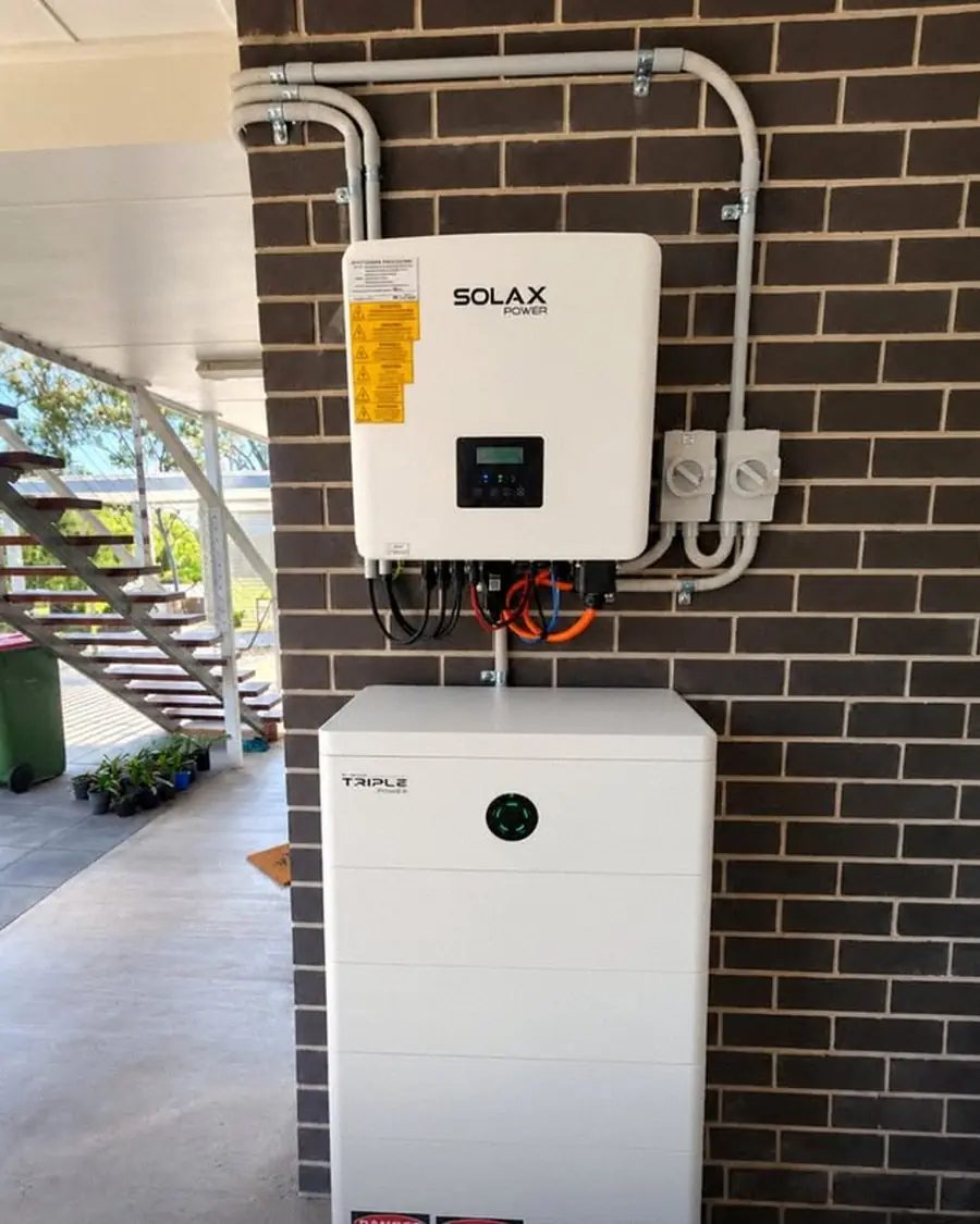 Solar inverter and battery mounted on a brick wall